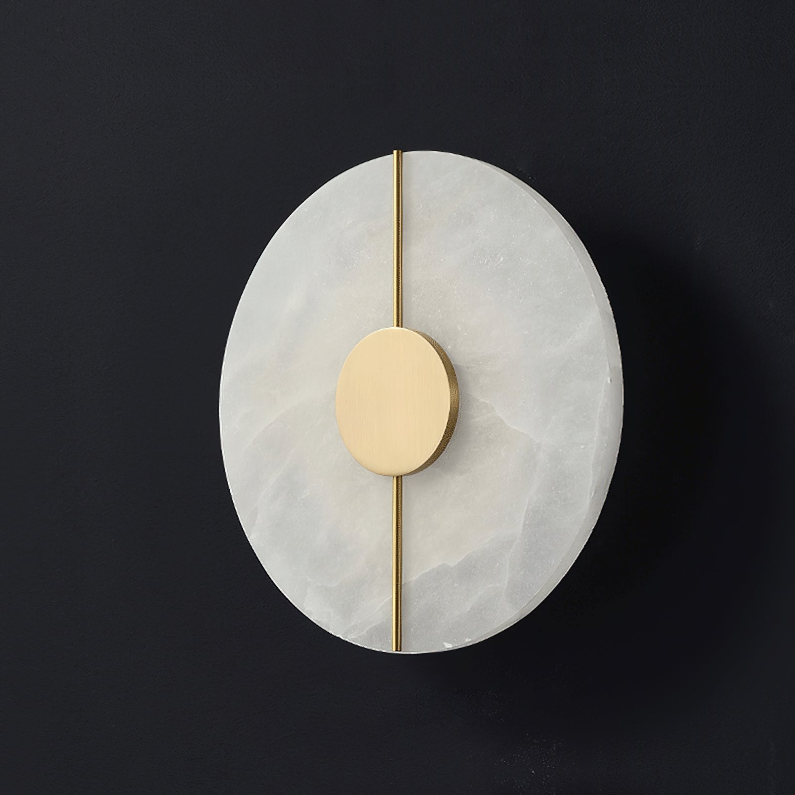 Clérachic round wall lamp unlit against dark grey, the brushed brass disc and slim rod crossing pale alabaster.