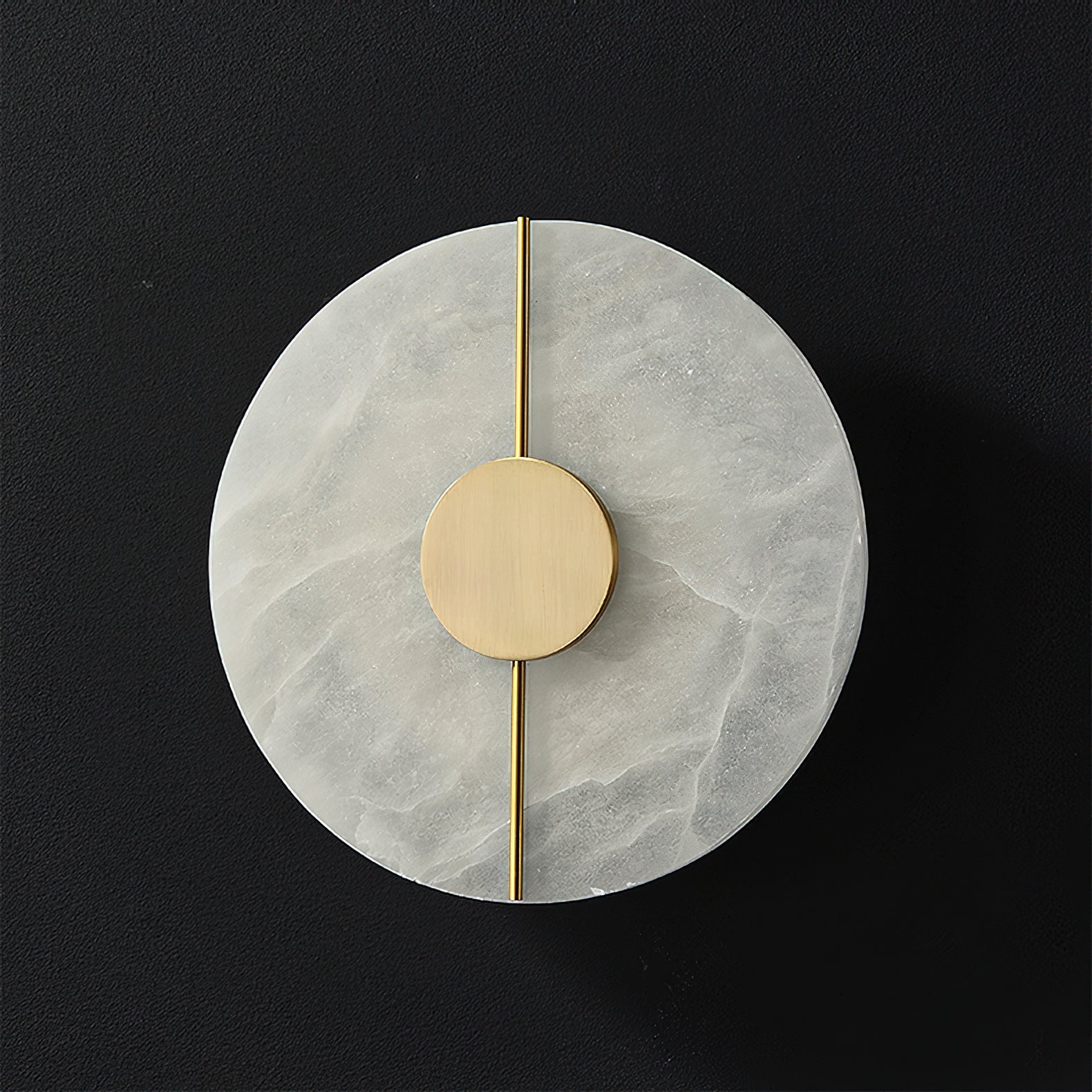 The Clérachic round alabaster wall lamp photographed unlit on black, its brass rod running the full width.
