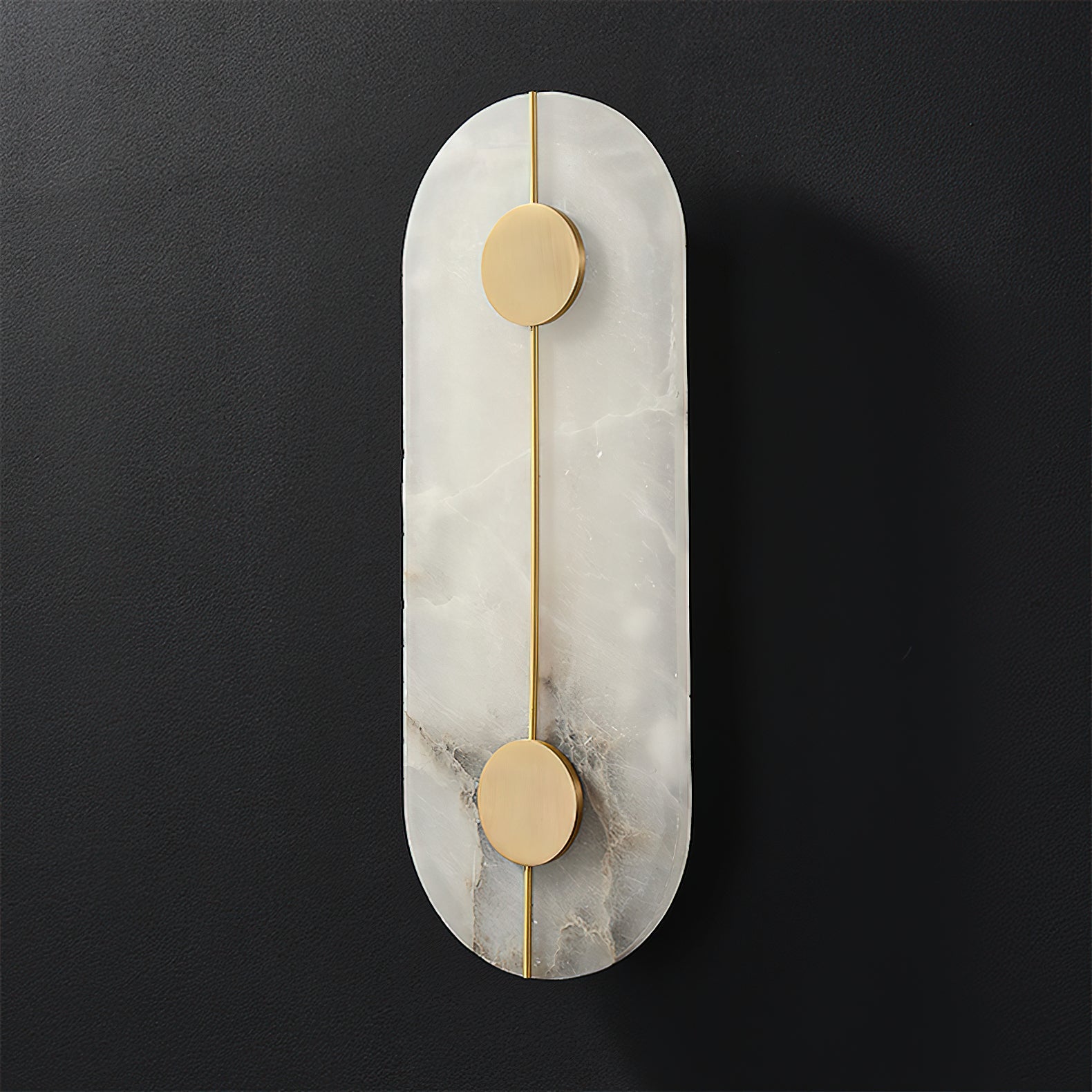 Clérachic tall alabaster wall lamp shown unlit, two brushed brass discs pinned along its slender rod.