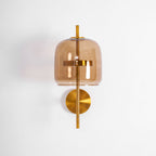 Front view of this Clérachic wall light, with a coffee glass shade, gold ring, gold stem and round backplate, unlit on white.