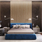Pair of Clérachic wall lights with white cones and curved arms above a blue velvet bed, in front of a slatted wood panel.