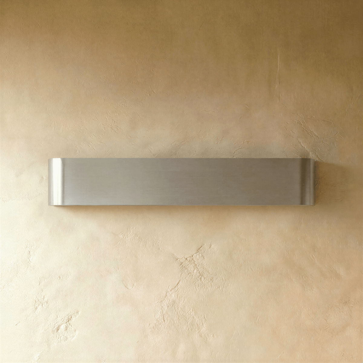 Clérachic long brushed silver aluminium wall light switched off, showing its fine horizontal grain on textured plaster.