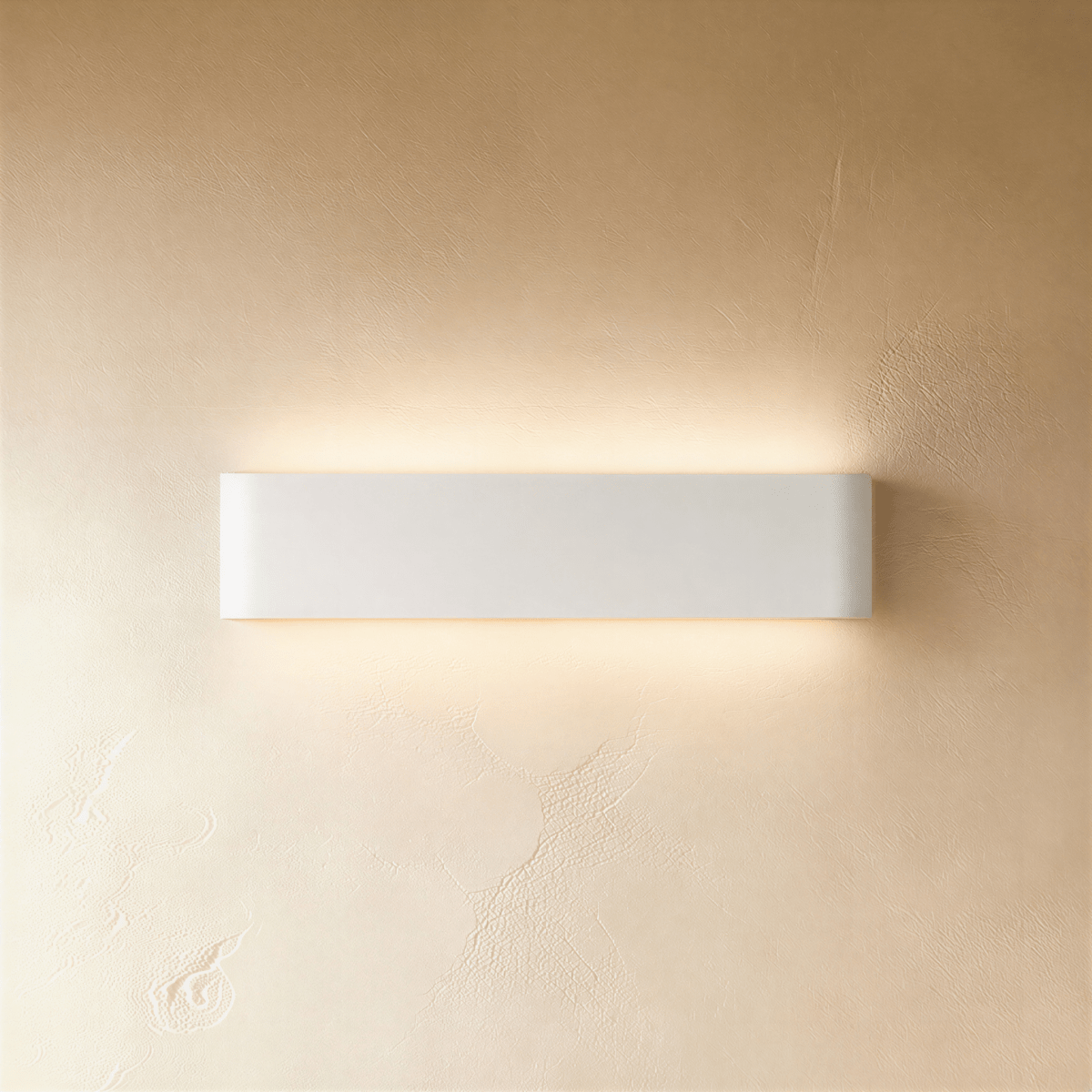 Clérachic white aluminium wall light in a medium length, lit up and down against a softly textured limewash wall.