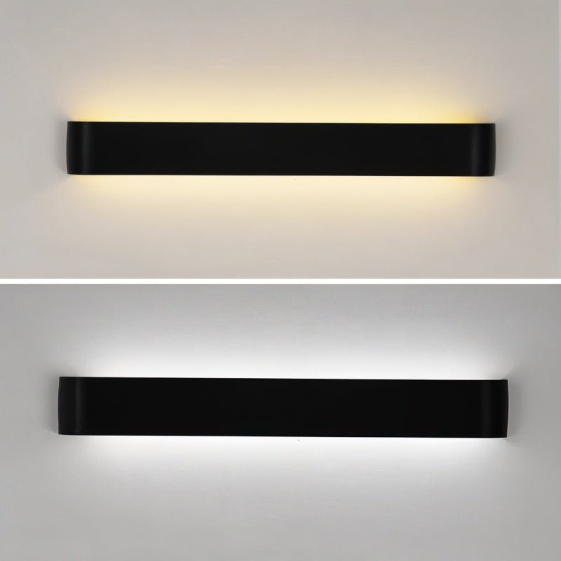 Clérachic long black aluminium wall light shown twice, lit in a warm white glow above and a cool white glow below.