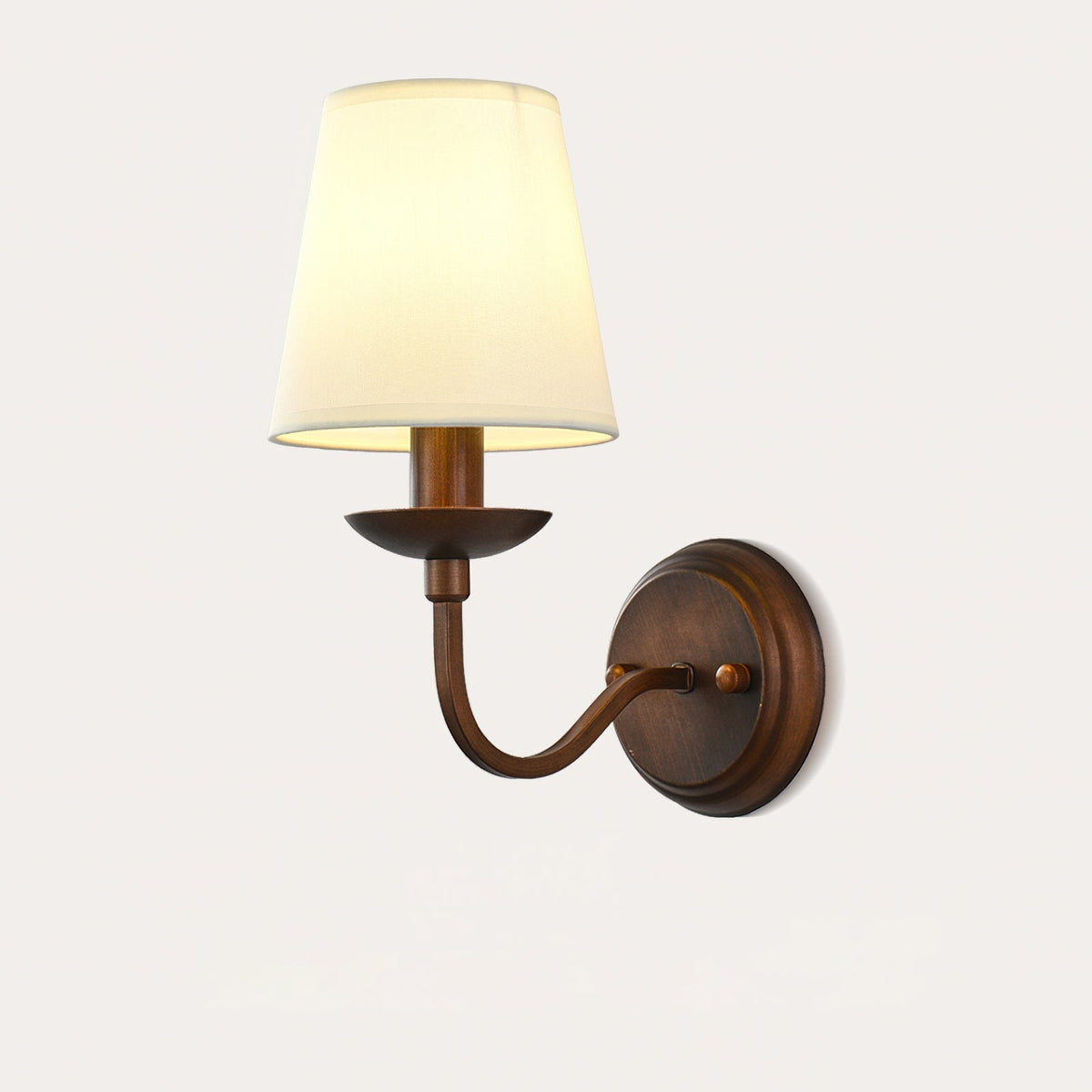 Clérachic wall light with a graceful curved arm, a shallow brown dish and a cream fabric shade, on a light backdrop.