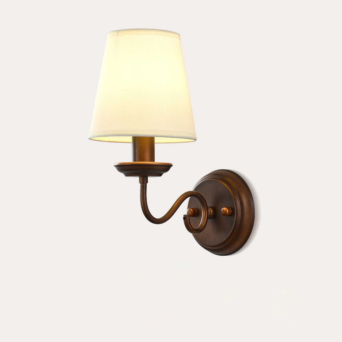 Clérachic wall light with a scrolled brown arm and a cream shade on a white background, shown from slightly below.