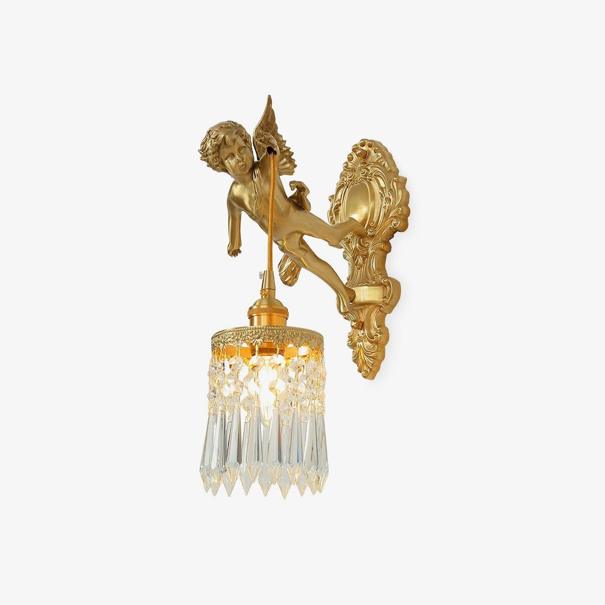 Gilded cherub wall light from Clérachic with a crystal-fringed drop shade, shown on a plain white backdrop.