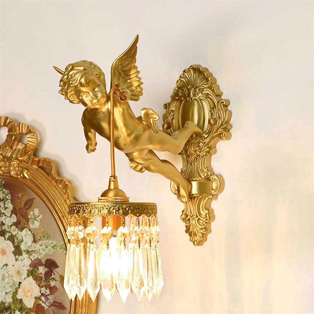 Close to a gilt-framed floral picture, a Clérachic wall light holds its crystal shade from the cherub's raised hand.