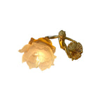 A Clérachic cherub wall light with a frosted rose shade and a round scrolled back plate, cut out on a plain white background.