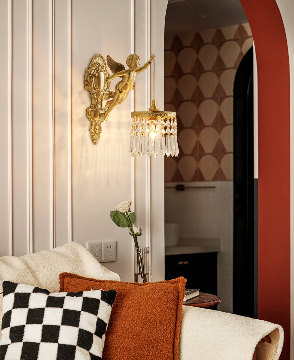 A Clérachic cherub wall light glows beside a red arch and a sofa with a chequered cushion and a rust-coloured pillow.