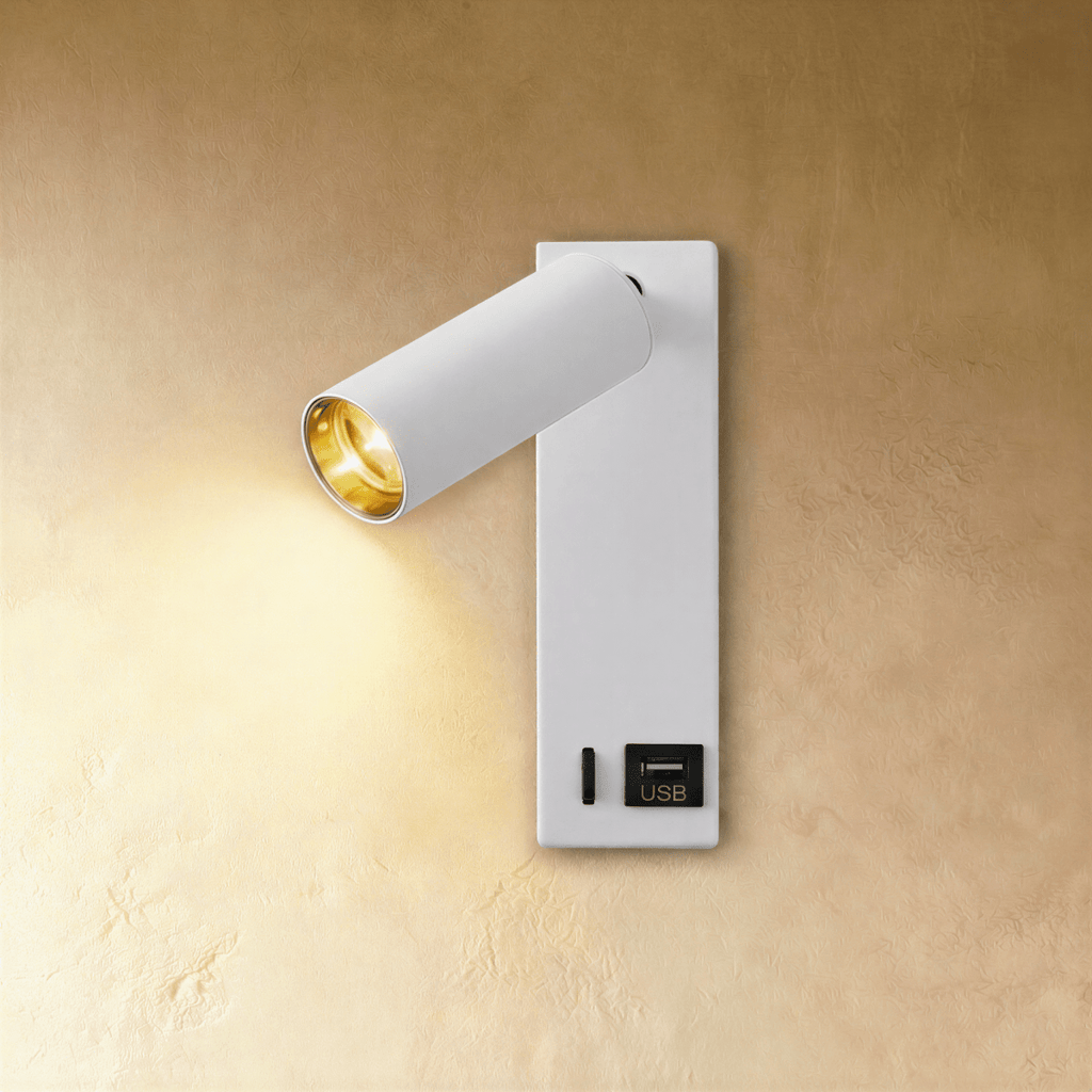 Clérachic white wall reading light lit warm, with a USB socket labelled on the lower backplate beside a small slot.