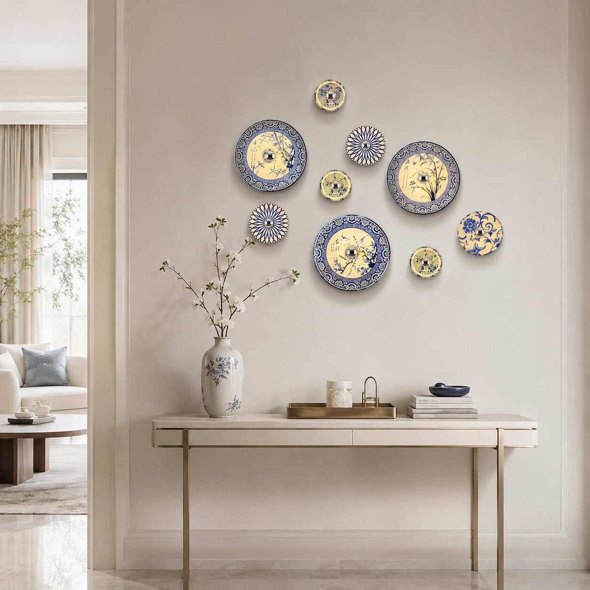 A group of Clérachic porcelain wall lights in several sizes and patterns, arranged as a cluster above a console table with a vase of blossom.