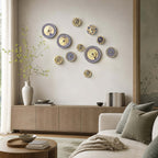 Ten Clérachic wall lights in mixed blue and white patterns scattered across a wall above a low sideboard and sofa.