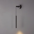 Black tube wall light on a grey wall, a faint warm glow just visible at the lower edge, from Clérachic.