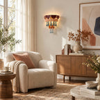 Sunlit corner with a Clérachic wall sconce above a wooden sideboard, a cream armchair with a terracotta cushion and an abstract print.