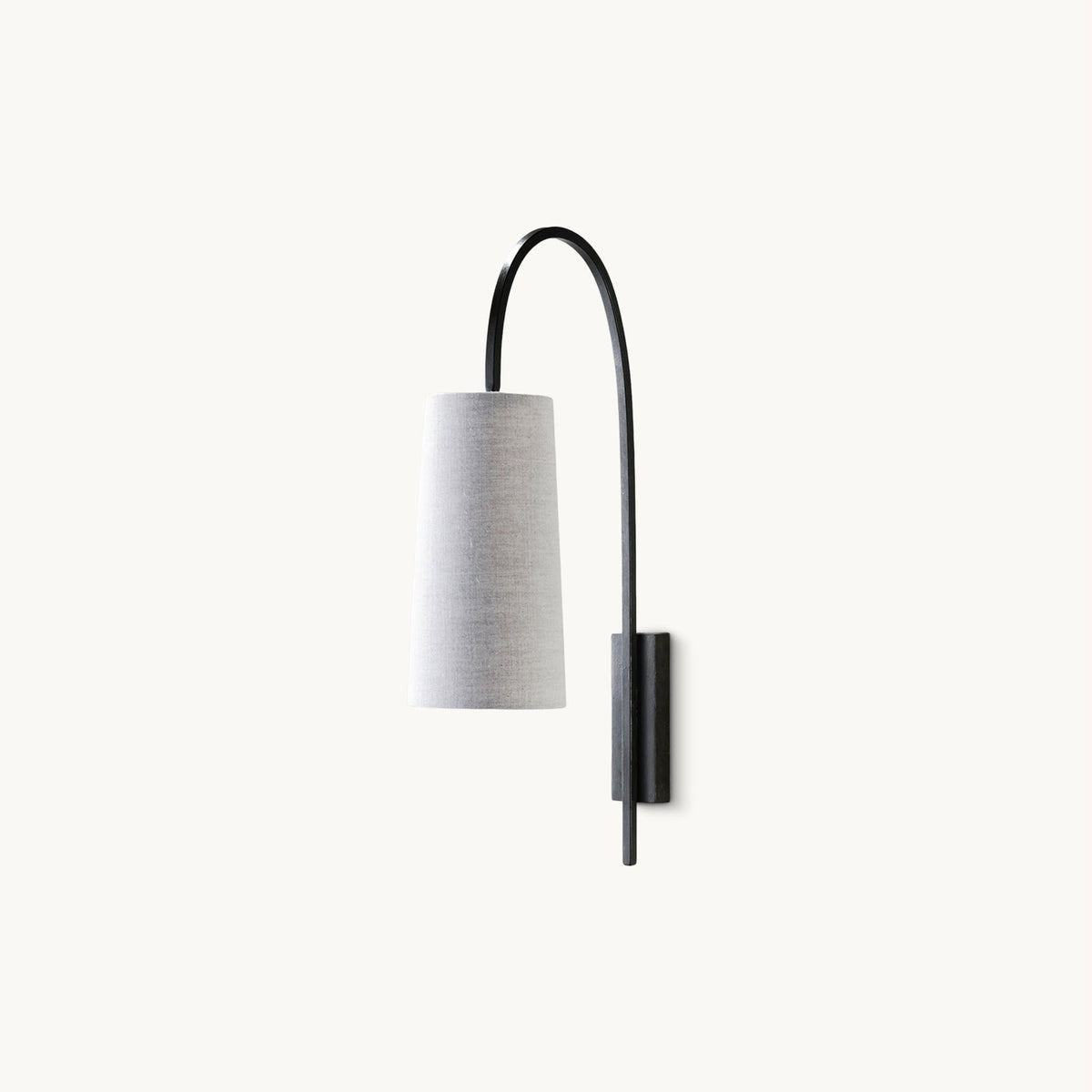 A Clérachic wall light with a tall curved black arm and a tapered fabric shade, on a plain white backdrop.