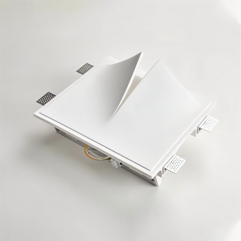 Angled view of a Clérachic white wall light with its square mounting frame, fixing tabs and wiring visible at the back.