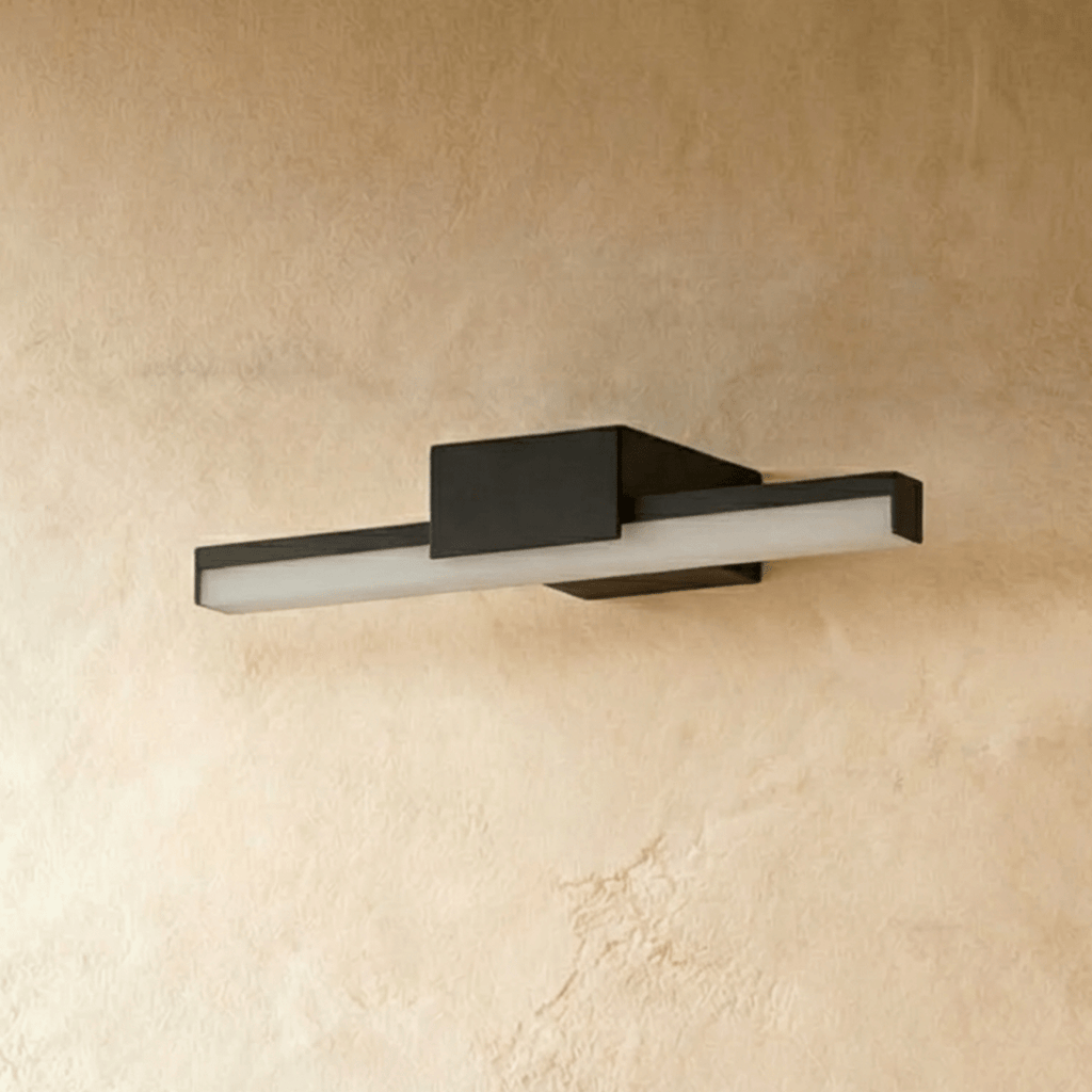 Clérachic short black linear bar wall light with a frosted diffuser, shown unlit on a warm plaster-effect wall.