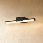 Clérachic mid-length black linear wall light with frosted diffuser and square mount, lit warm on a limewash wall.
