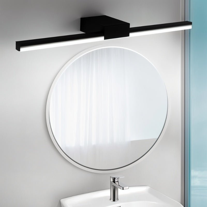 Clérachic black linear wall light mounted above a round white-framed mirror and basin in a bathroom.