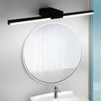 Clérachic black linear wall light mounted above a round white-framed mirror and basin in a bathroom.