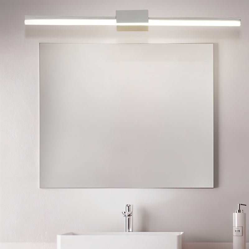Clérachic long white linear wall light above a frameless rectangular mirror and white basin in a bathroom.