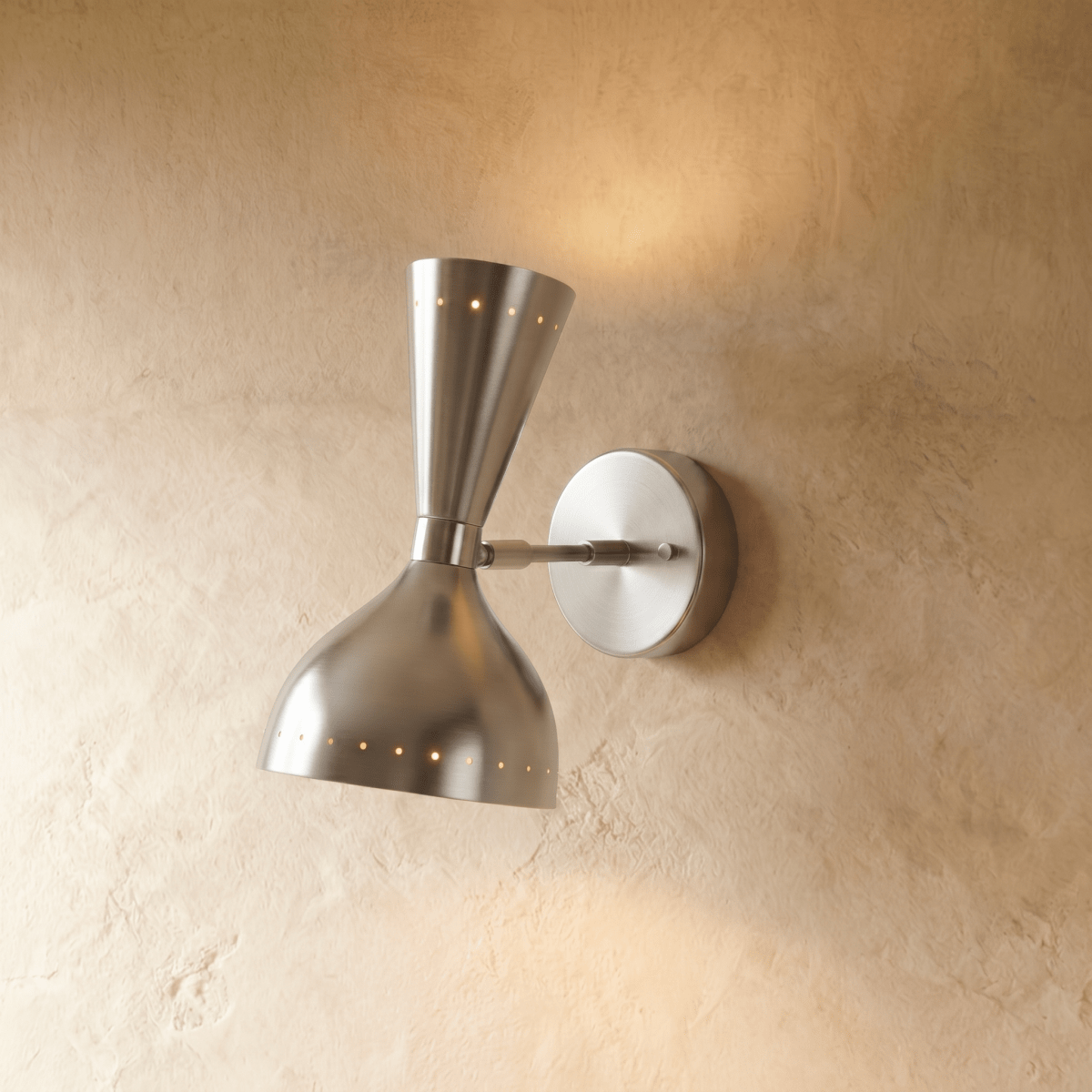 Clérachic wall lamp in chrome, an hourglass shade with perforated rims on a round wall plate.