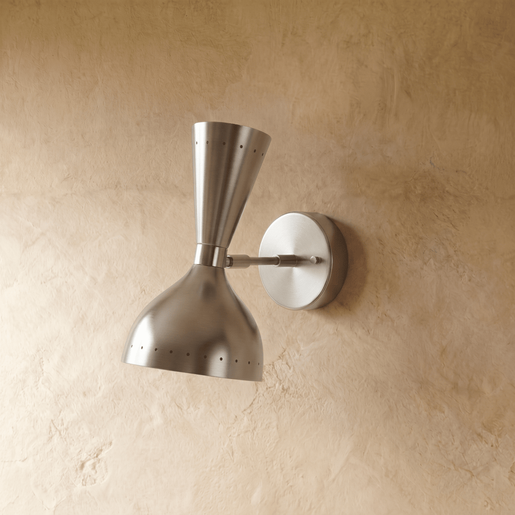 Clérachic wall lamp in chrome shown from another angle, pinpoints of light rimming both cones.