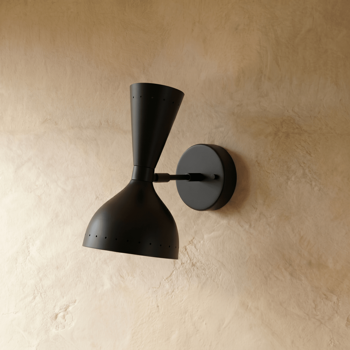 This Clérachic wall lamp in matte black viewed close, pinpoints of light rimming both cones.