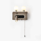A nickel Clérachic wall light with two frosted glass globes, a small reading spotlight and a pull chain, on a plain white backdrop.