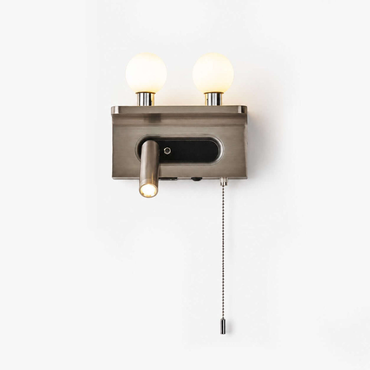 A nickel Clérachic wall light with two frosted glass globes, a small reading spotlight and a pull chain, on a plain white backdrop.