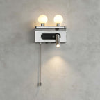 A chrome Clérachic wall light on a concrete-look wall, its spotlight throwing a soft circle of light below the backplate.