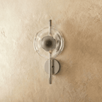 Clérachic wall light with a clear rippled glass disc on a polished chrome rod and round backplate, switched off.
