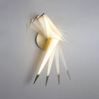A multiple-exposure view of this Clérachic bird wall light swinging from side to side on its gold perch against a grey wall.