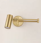 Close view of a Clérachic gold wall light with a folded arm, its round backplate and the cylinder head with a frosted lens.