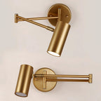 Two Clérachic gold wall lights in close view, one with the arm folded flat and one with it swung out from the backplate.