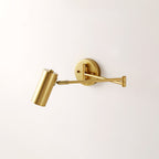 Clérachic gold wall light with its arm folded back at the elbow and a cylinder head tilted to one side.