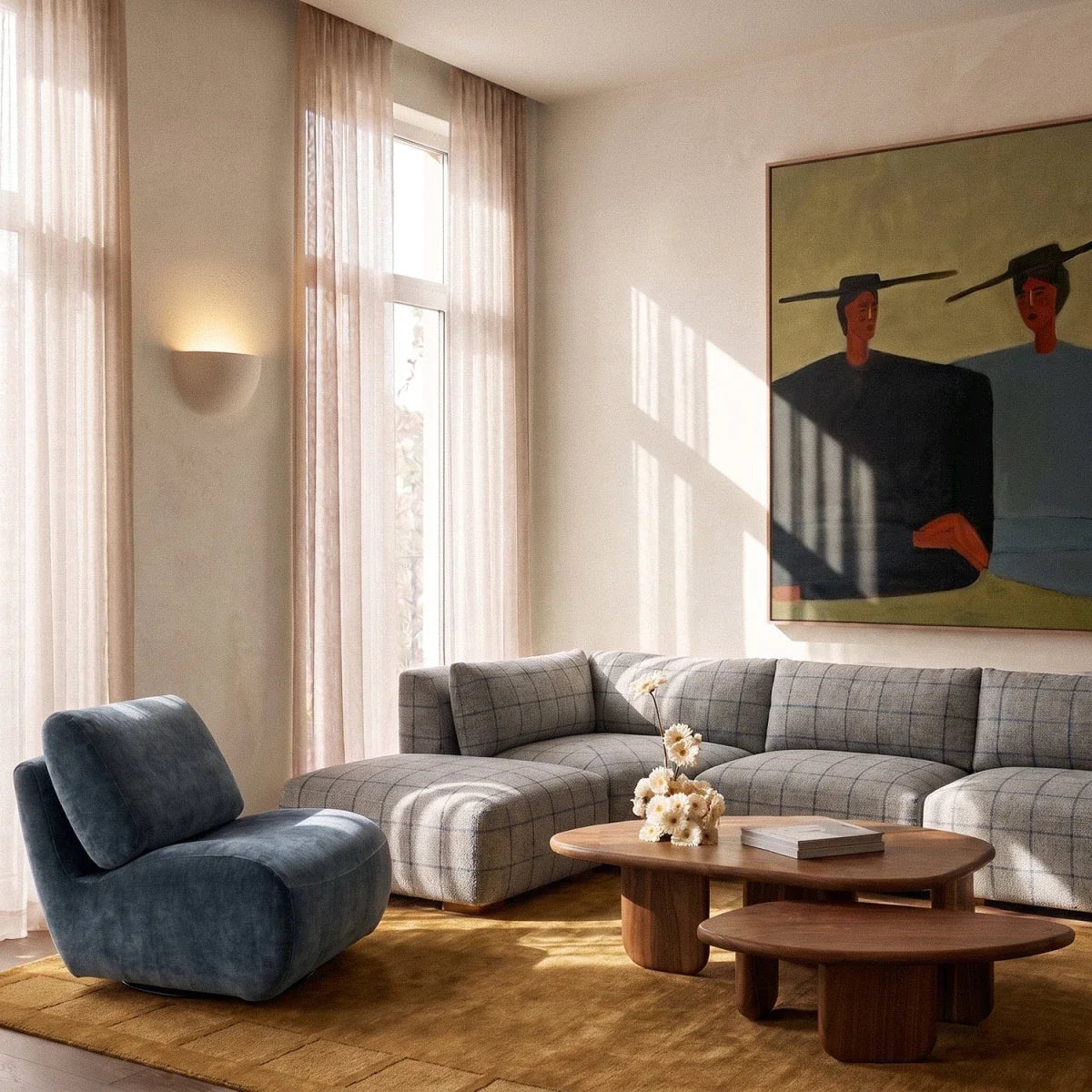 Clérachic half-moon plaster wall light glowing beside tall sheer curtains in a living room with a plaid sofa.