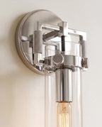 Clérachic close view of the polished chrome sconce, its knurled thumbscrews, square bracket and amber filament bulb.