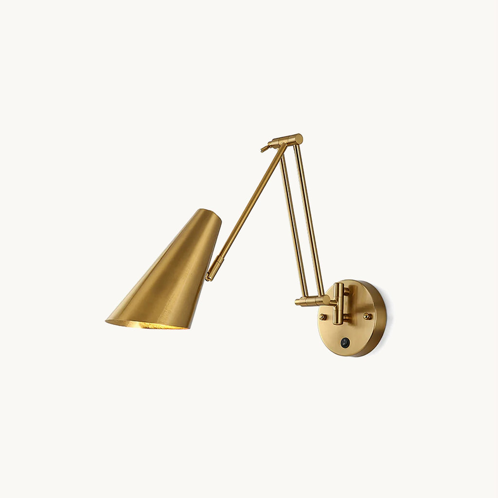 Clérachic gold swing-arm wall light with a conical metal shade, a folding double arm and a round backplate with a small switch, on white.