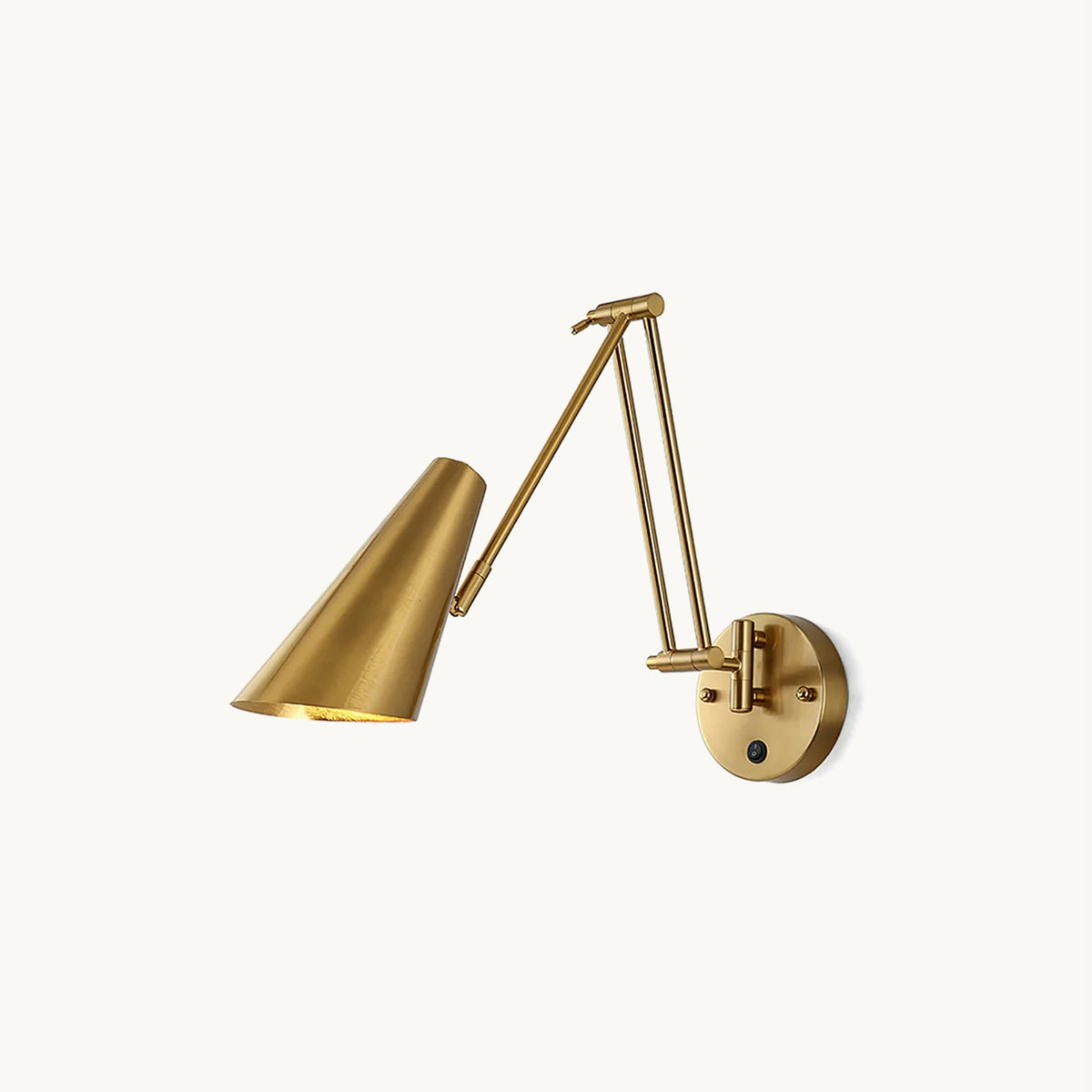 Clérachic gold swing-arm wall light with a conical metal shade, a folding double arm and a round backplate with a small switch, on white.