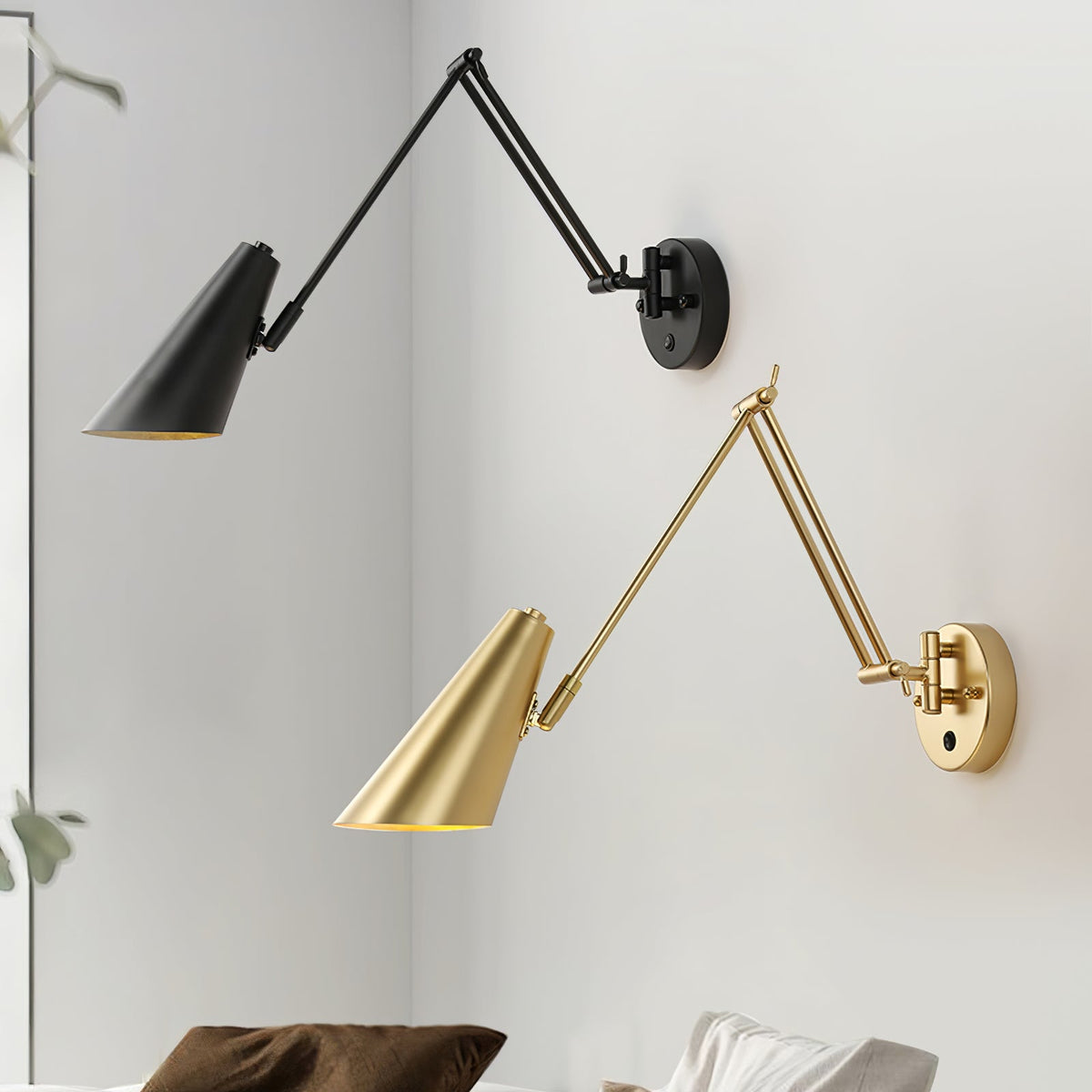 Two Clérachic swing-arm wall lights with conical shades, one black and one gold, mounted on a white corner wall above a bed.