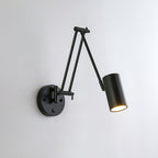 Black Clérachic wall light with a cylinder head on a folded double arm and a round backplate, on a pale grey wall.