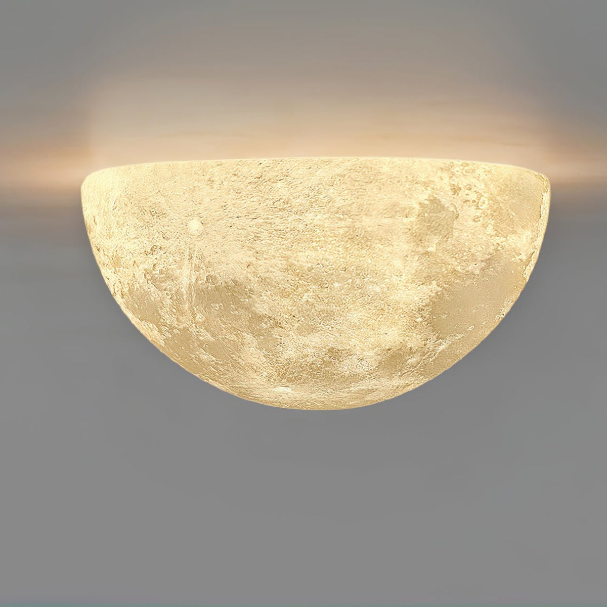 Clérachic half-moon wall light mounted flat side up, with light spilling along the top edge against a grey wall.