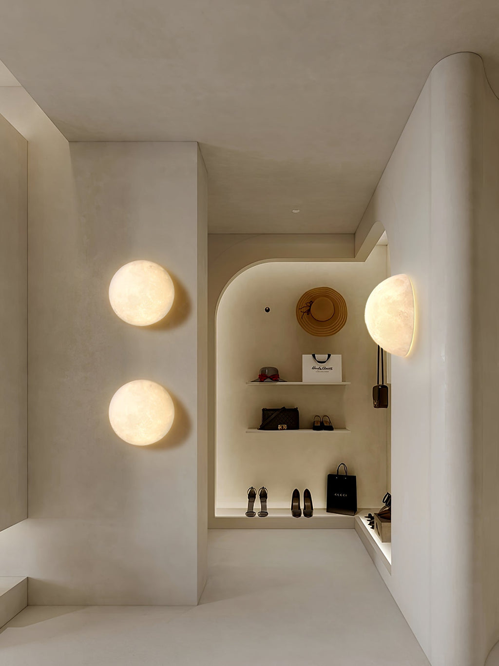 Clérachic moon wall lights in a pale boutique corridor, two round ones and a half-moon beside shelves of shoes.