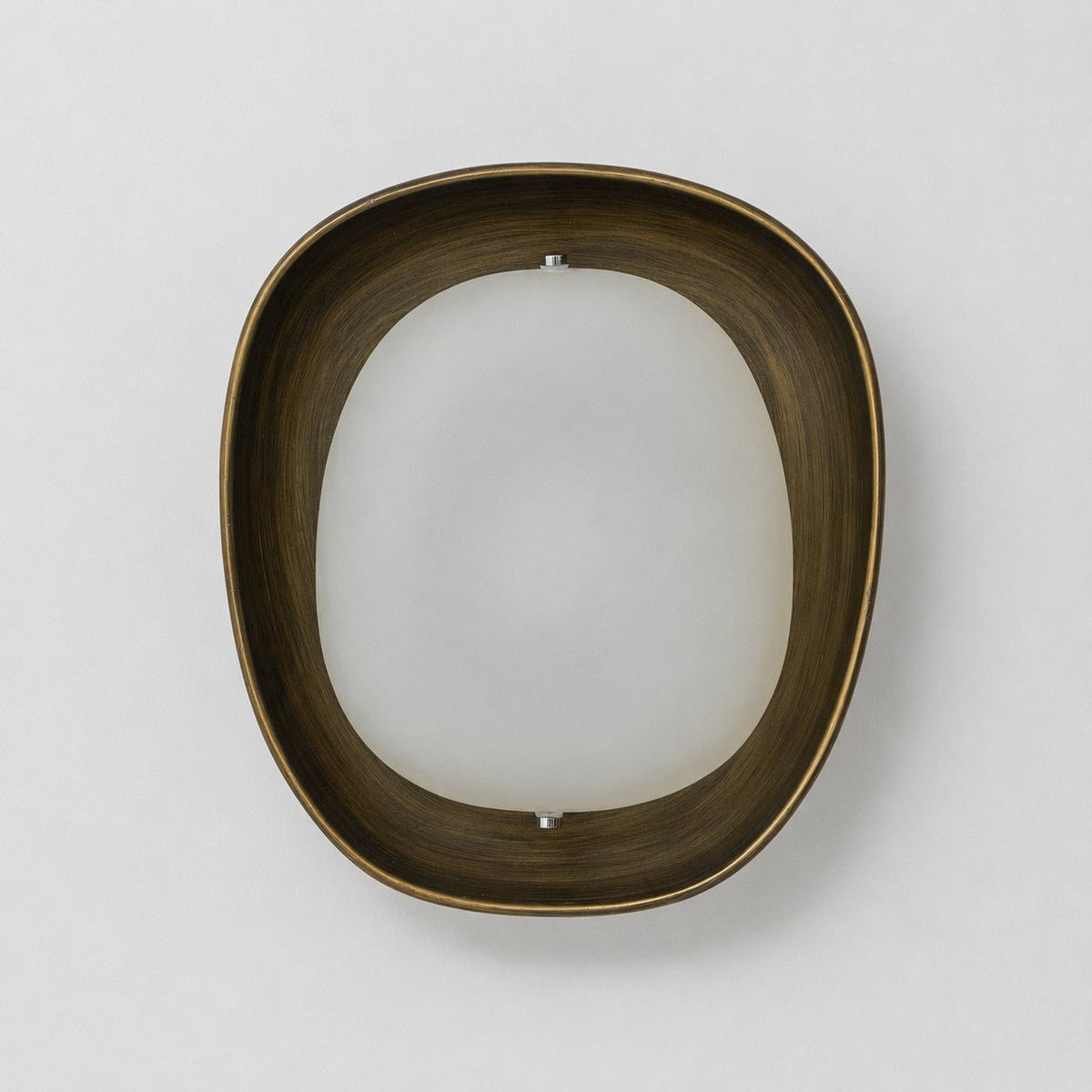 Straight-on view of a Clérachic wall light switched off, with a dark bronze rim around a frosted white oval shade, on a pale wall.