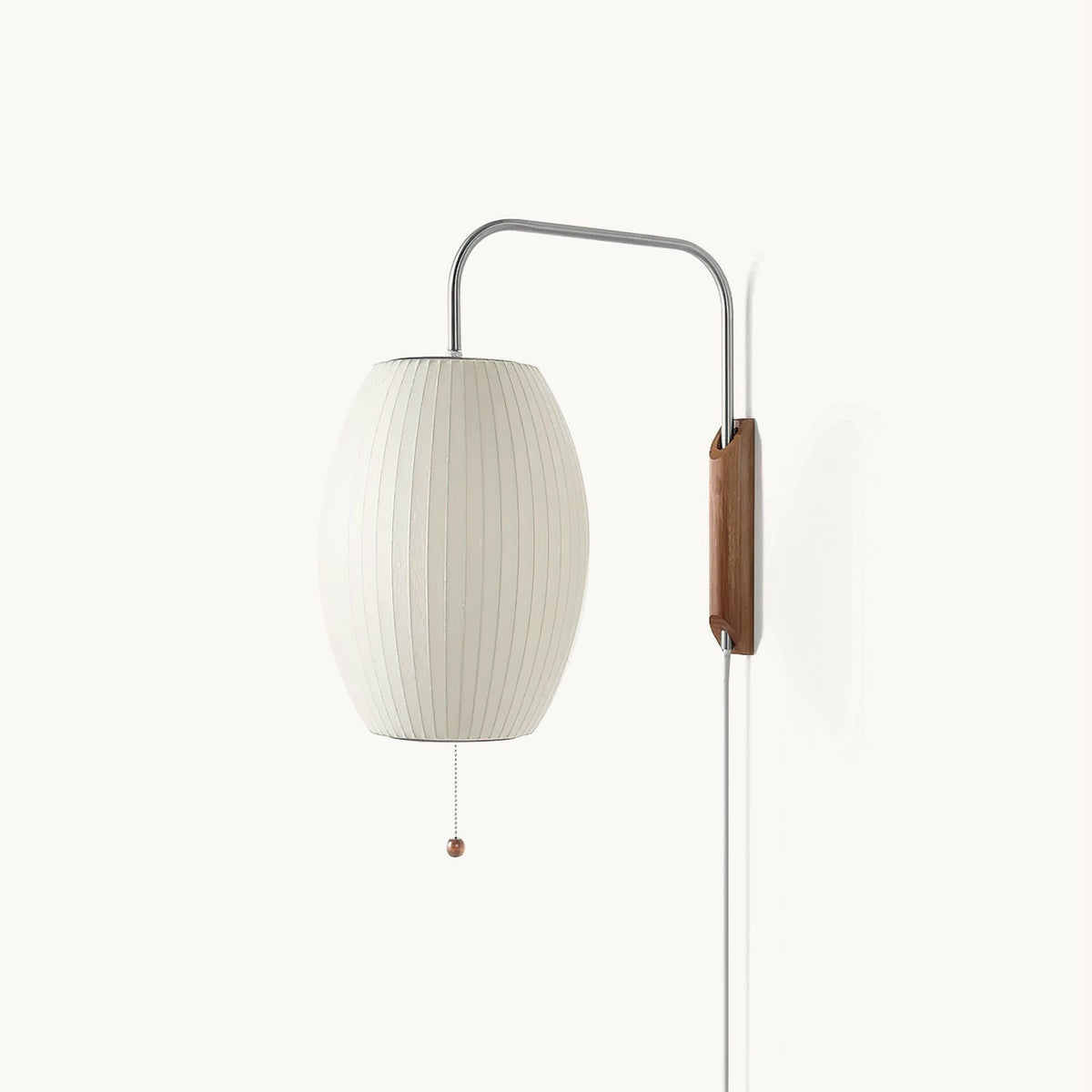 White ribbed oval shade on a curved steel arm with a walnut-toned wall bracket, shown on a plain white backdrop as a Clérachic plug-in wall light.