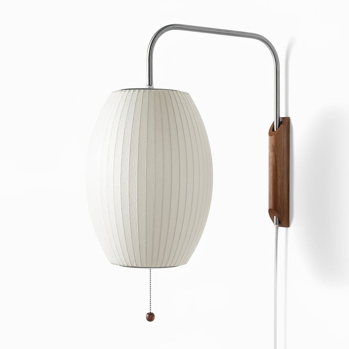 Large view of the oval shade, steel arm and walnut bracket of this Clérachic wall light on a bright white backdrop.