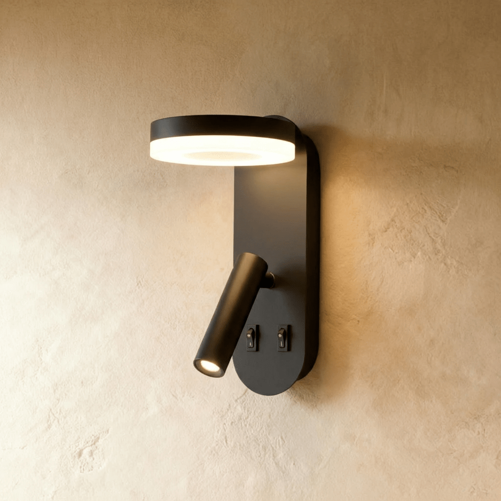 Clérachic matte black wall reading light with a lit circular LED ring above a swivelling tube spotlight and two switches.