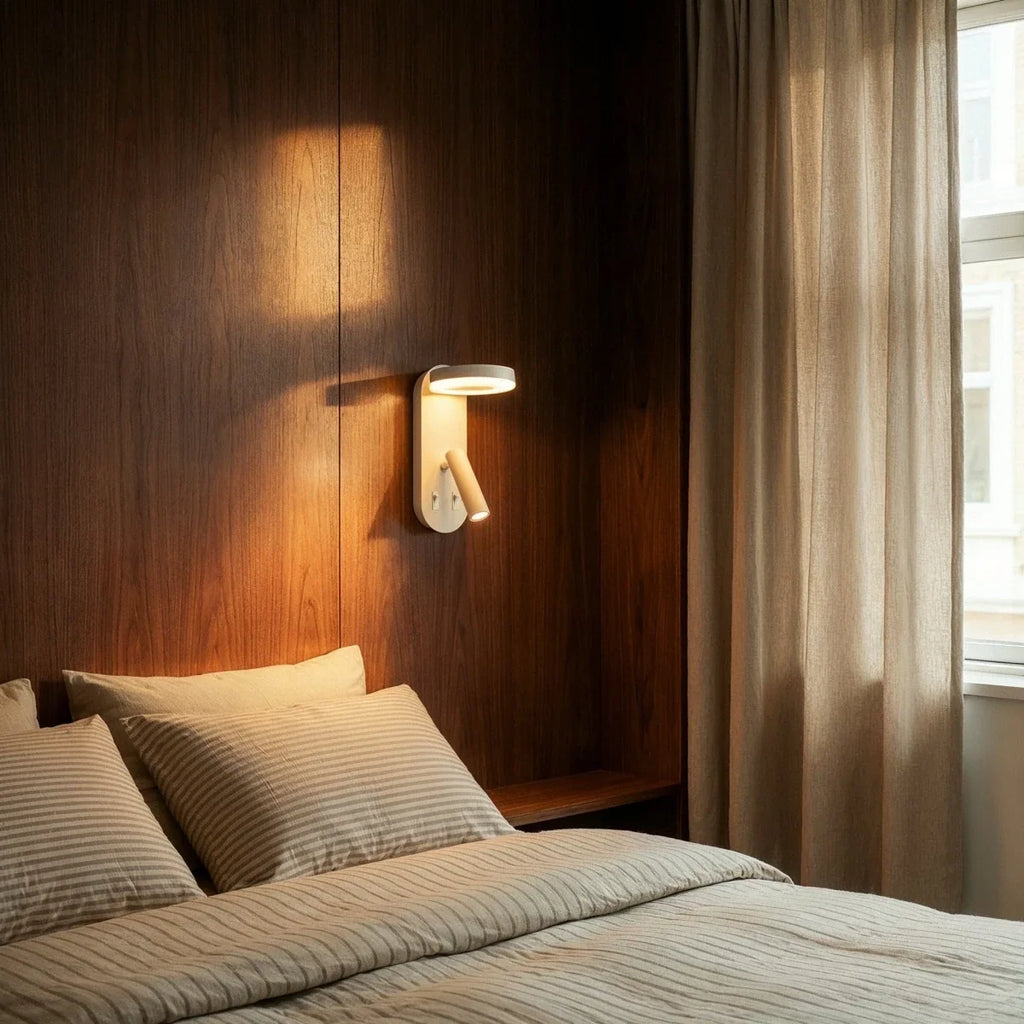 Clérachic white wall reading light mounted on walnut panelling above a bed with striped linen and sheer curtains.